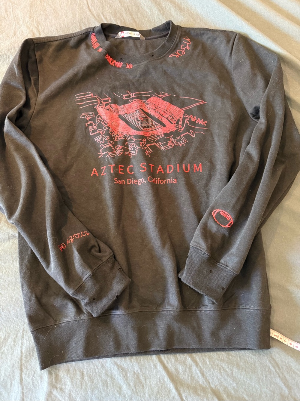 Aztec Stadium Black Crewneck Sweatshirt with Red Graphic